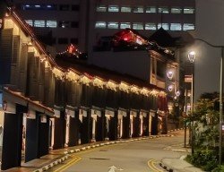 Rows of lighted heritage shophouses at Eskine Rd.