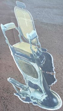 Mural of an antique barber chair by Unknown Artist on Sago St.