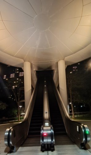 Escalator to Bridge to Marina Bay Sands and The Shoppes.