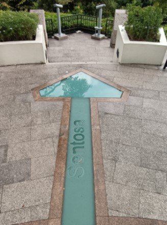Arrow on the floor that is pointing to Sentosa.