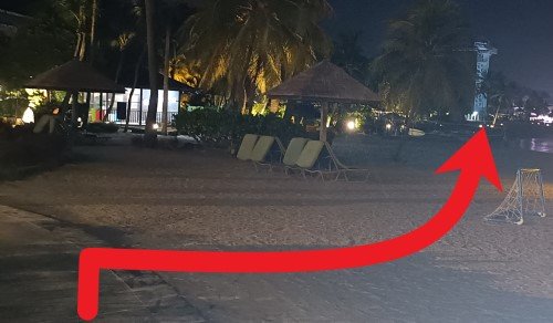 Walk from the unsheltered walkway onto the beach and walk towards Siloso Beach.