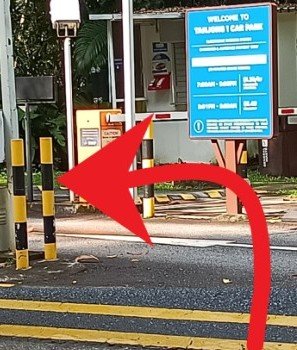 When you see the WELCOME TO TANJONG 1 CAR PARK sign,  cross the road, turn left  into the car park and keep to the right.