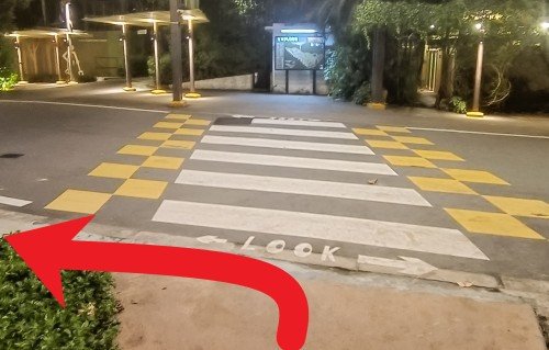 Turn left before the zebra crossing and follow the sheltered walkway.