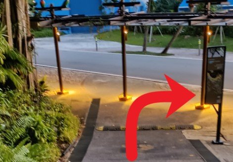 Walk down the unsheltered walkway, turn right, follow the sheltered walkway.