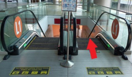Take the escalator to the ground floor.
