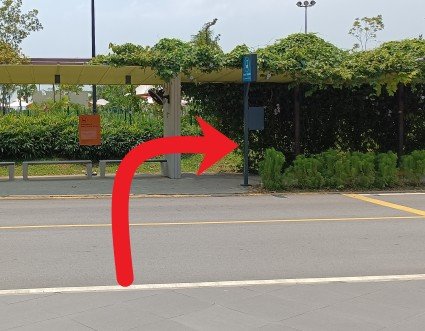 Cross the road to the Beach Shuttle stop, turn right, follow the sheltered walkway.